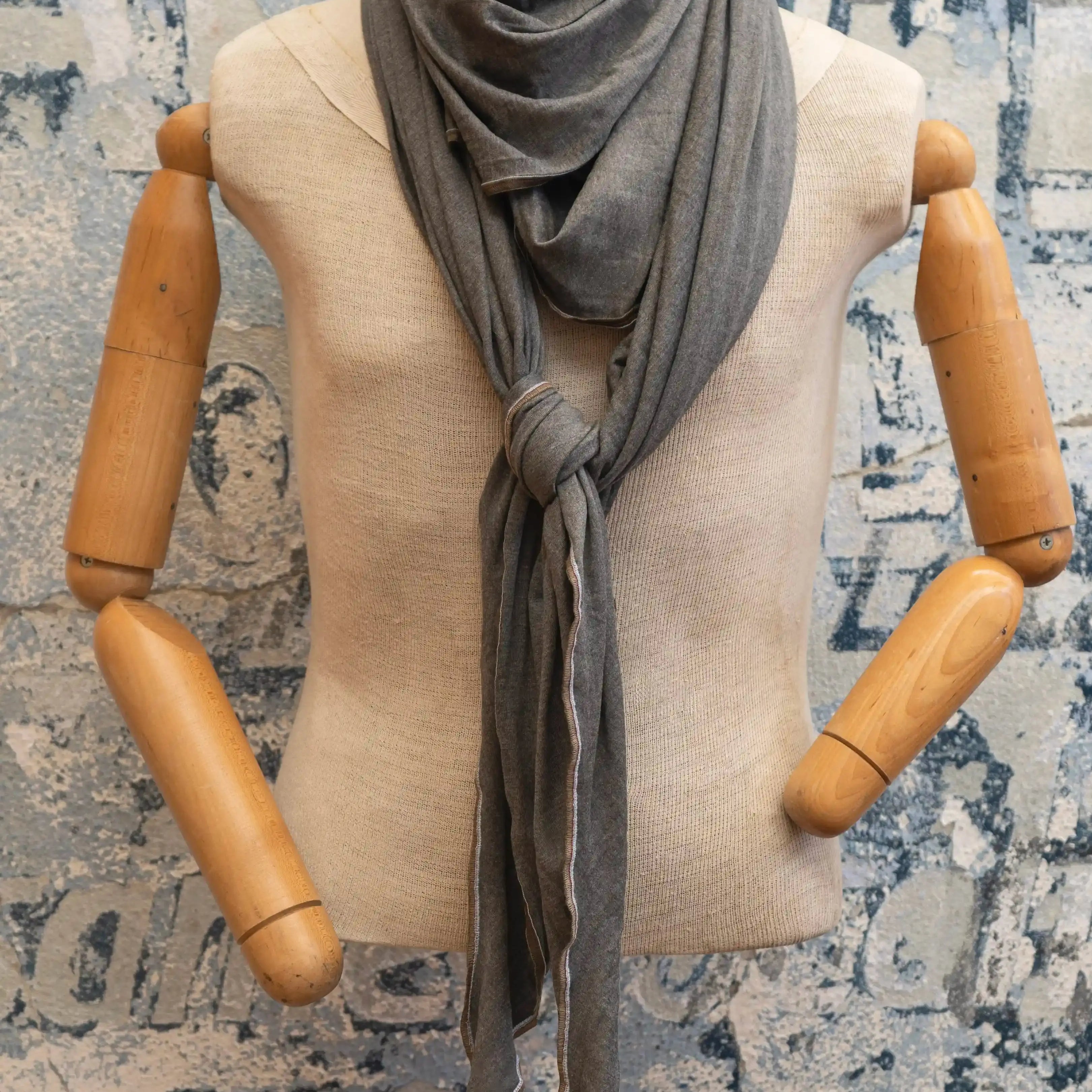 Retro 70’s style scarf with earthy tones and vintage pattern draped on sweater