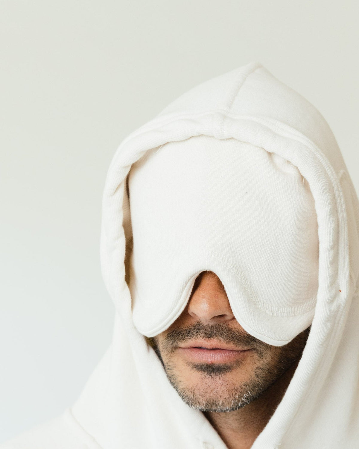 The built-in eye mask folded down from the hood of a cream Apollo X