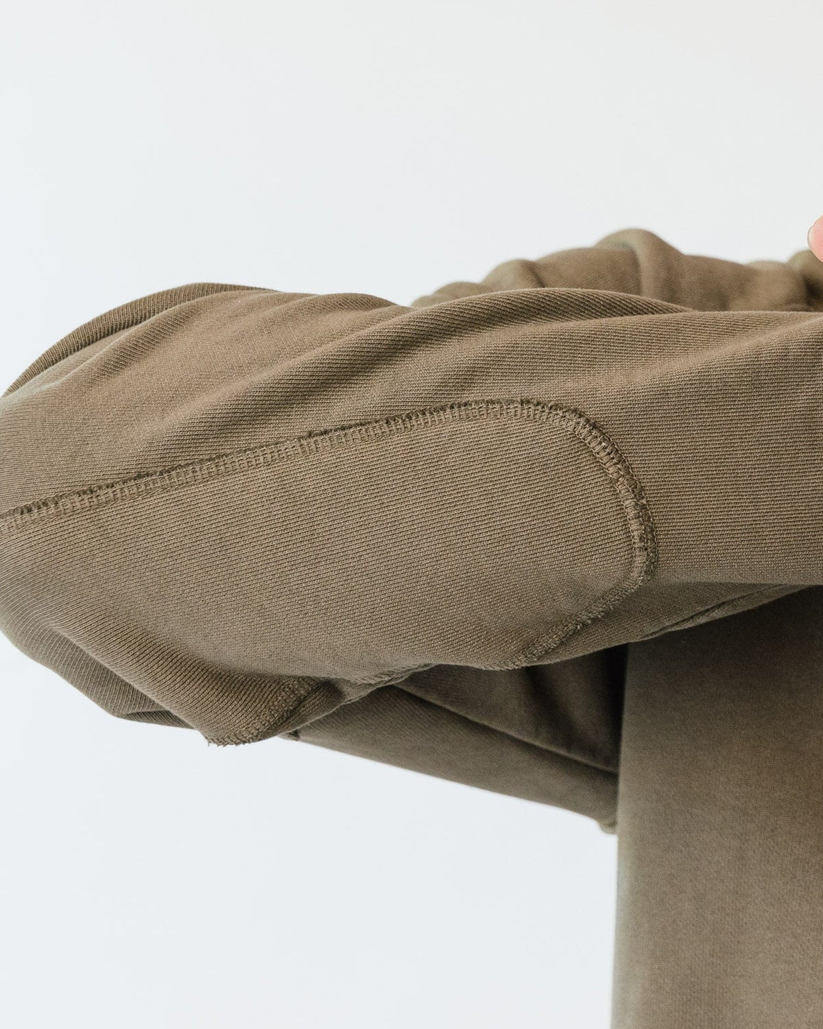 The padded panel stitched along the forearm of an olive Apollo X sleeve